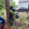 One of the kids watering plants 