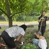 Christel directing Kymani on how to plant his coral bell!