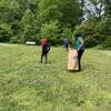 Three volunteers pick up trash in the field at Cherry Ann Park