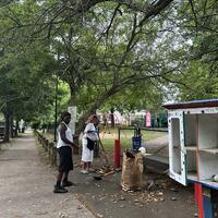 Raking leaf litter outside Cedar Hill playground