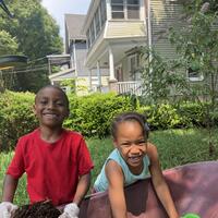 Smiles while loading the buckets with mulch!