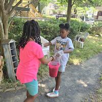 Passing down buckets of mulch!