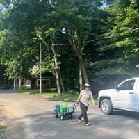 Margaret bringing water to water young shrubs and dogwood!