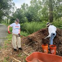 Sandy and Clara loading mulch to spread on the path!