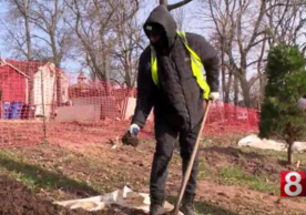 A member of the tree planting crew outside digging.