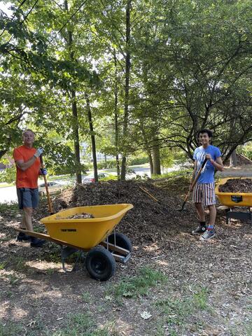 David and youth shoveling mulch